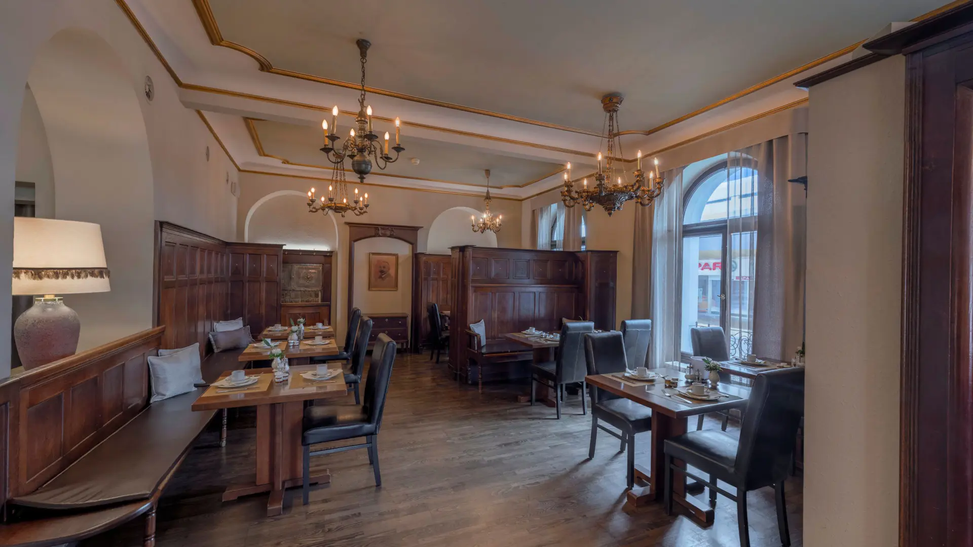 Elegantes Restaurant mit Holzmöbeln und Kronleuchtern.