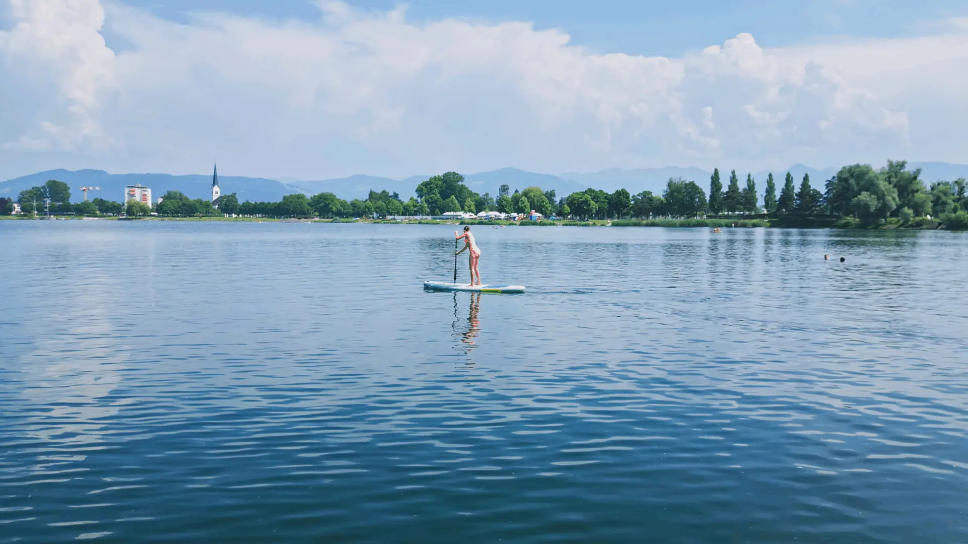 Person auf SUP-Board auf See.