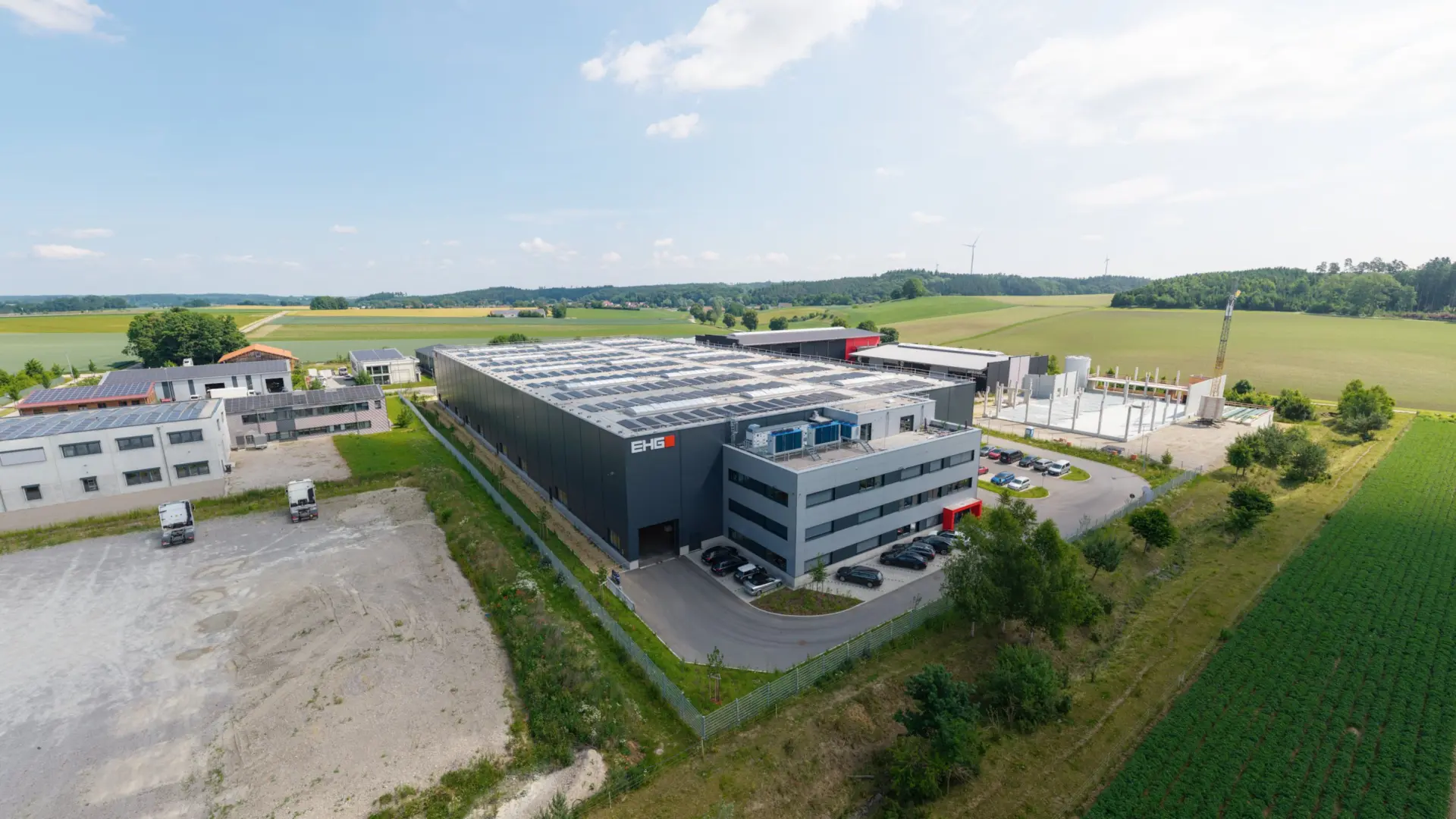 Moderne Fabrik in ländlicher Umgebung mit Solaranlagen