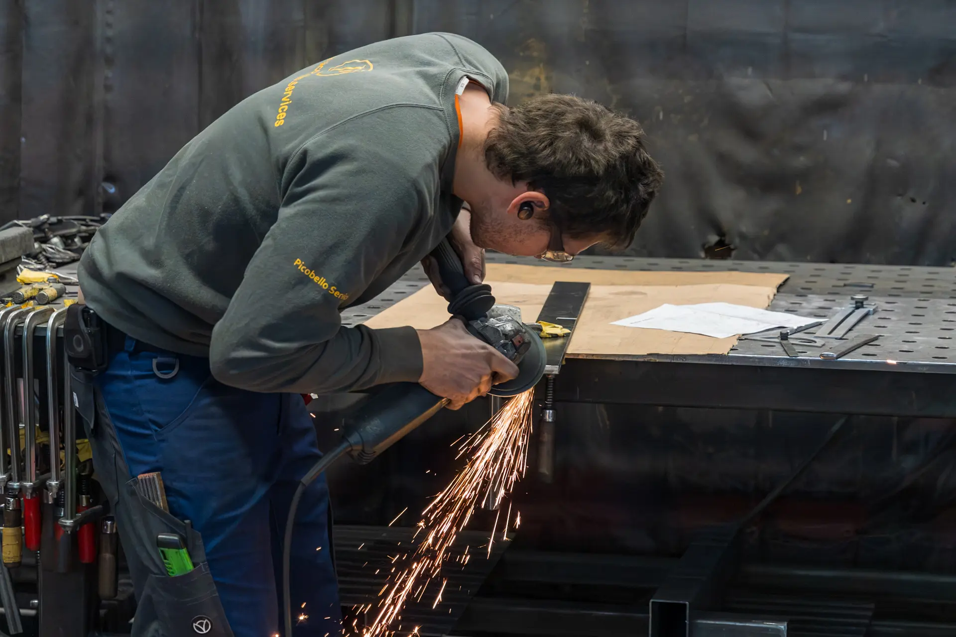 Handwerker schleift Metall mit einer Maschine.